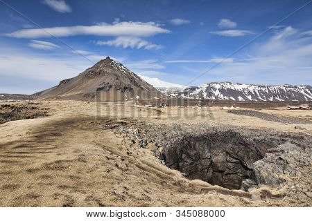 A Blowhole And The Mountain Stapafell At The Beautiful Village Of Arnarstapi, Snaefellsnes Peninsula