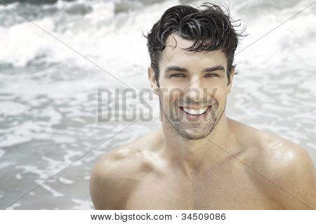 Handsome happy man smiling with ocean water background