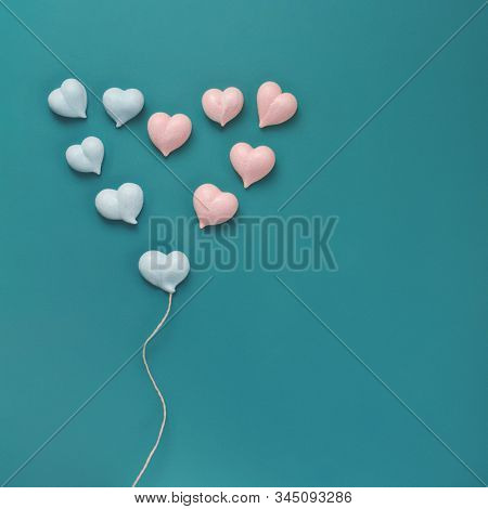 Eleven Small Meringues Of Pink And Blue Hearts Are Laid Out In Big Heart With With Rope Made Of Natu
