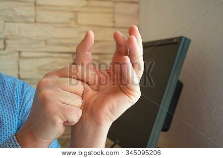 Concept Photo Of Pain Or Spasm In Thumb. Man Hold Thumb With Palm Of The Other Hand, Which Muscles O