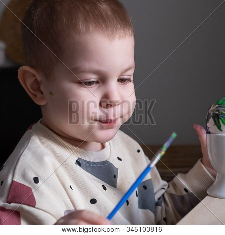 Toddler Boy Painting Easter Eggs Preparing For Holidays. Easter Tradition