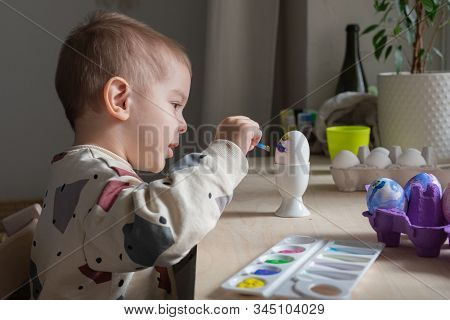 Toddler Boy Painting Easter Eggs Preparing For Holidays. Easter Tradition