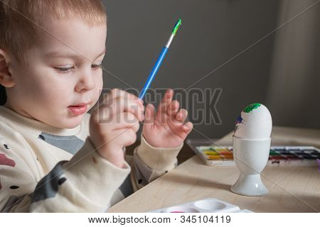 Toddler Boy Painting Easter Eggs Preparing For Holidays. Easter Tradition