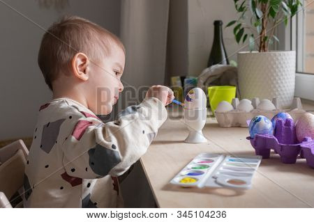 Toddler Boy Painting Easter Eggs Preparing For Holidays. Easter Tradition