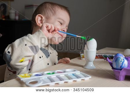 Toddler Boy Painting Easter Eggs Preparing For Holidays. Easter Tradition