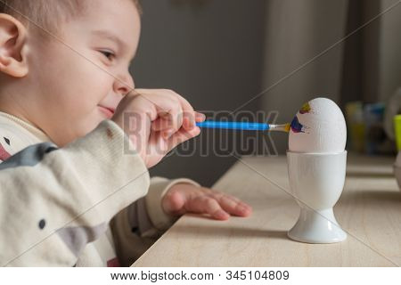 Toddler Boy Painting Easter Eggs Preparing For Holidays. Easter Tradition
