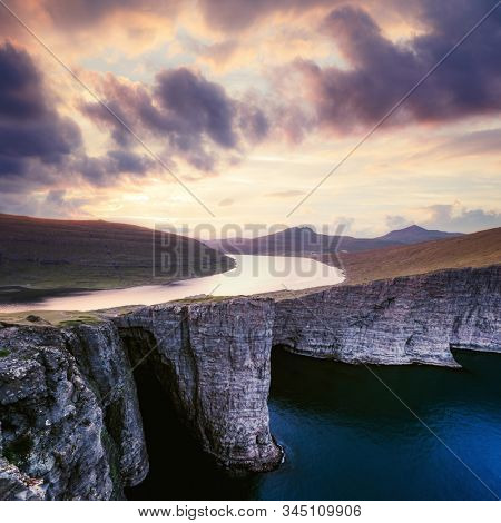 Incredible view of Sorvagsvatn lake on cliffs of Vagar island in sunset time, Faroe Islands, Denmark. Landscape photography