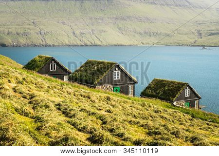 Picturesque view of tradicional faroese grass-covered houses in the village Bour during autumn. Vagar island, Faroe Islands, Denmark.
