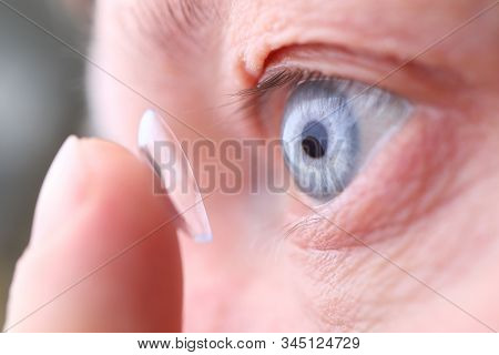 Man Putting On Soft Contact Lens Close-up