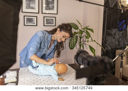 Female Vloger Recording Video About Cleaning Newborn Baby Ears With Safety Cotton Ear Buds As Part O