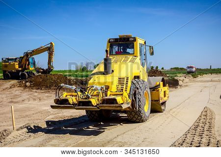Vibration Plate Compactor Is Mounted To The Steamroller, Compacting Sand At Road Construction Site.