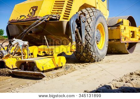 Vibration Plate Compactor Is Mounted To The Steamroller, Compacting Sand At Road Construction Site.