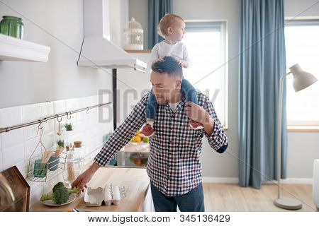 Cute Little Girl Feeling Great Sitting On Her Fathers Shoulders
