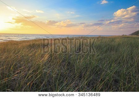 Summer Sunset Beach Background. Beautiful Summer Sunset On The Lake Michigan Coast With Dune Grass I