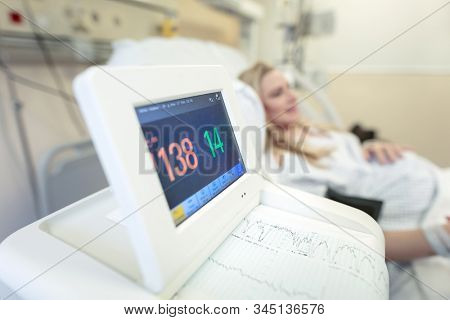 Pregnant woman in the prenatal hospital, expectant female on the third trimester checking her health before childbirth, happy healthy pregnancy