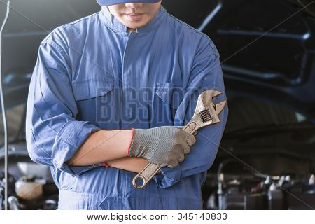 Man Mechanic Inspection Hold Wrench For Fix Blue Car For Service Maintenance Insurance With Car Engi
