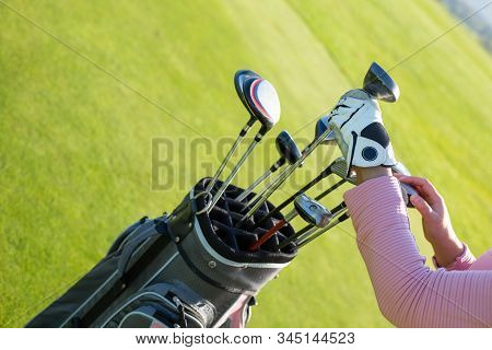 Professional Golf Player Choosing The Golf Club From The Bag