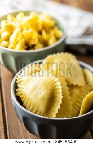 Italian stuffed pasta. Panzerotti pasta in bowl on wooden table.