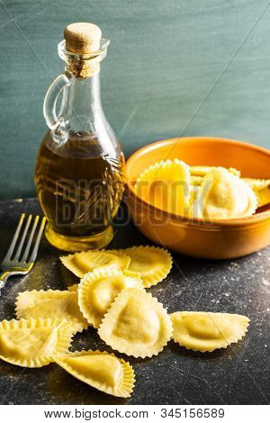 Italian stuffed pasta. Panzerotti pasta on old kitchen table.