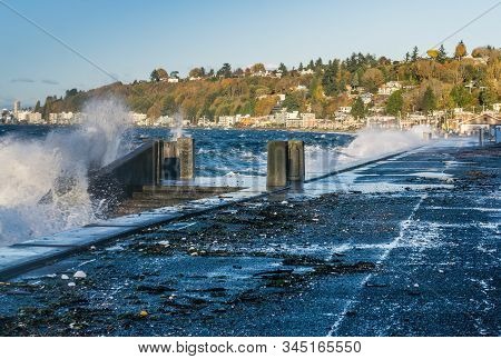 Waves Crash Onto The Shore At Alki Beach In West Seattle, Washington.