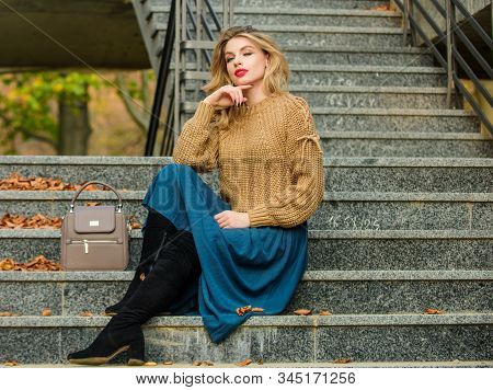 Lost In Thoughts. Casual Style Student. Fall Season. Girl In Corrugated Skirt And Sweater. Pleated T