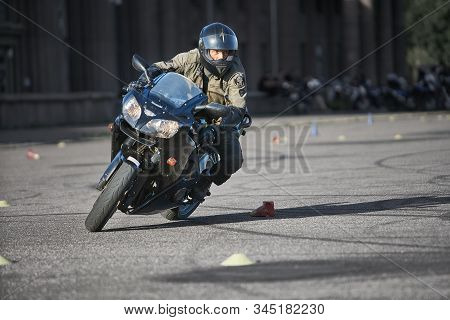 30-09-2019 Riga, Latvia. Motorcyclist On A Black Sports Motorcycle Rides On The Asphalt Ground