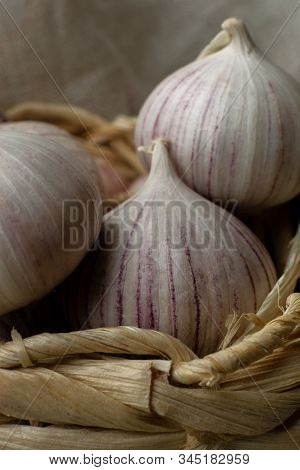 Three Solo Garlic In Wicker Basket Close-up Macro