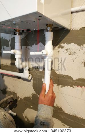 The Worker Feeds The Pipes To The Boiler To Heat The Floor.