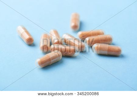 Goji Berry (wolfberry) Capsules. Immune System Support. Dietary Supplement On Bright Paper Backgroun