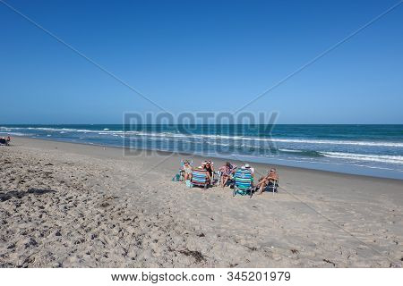 Vero Beach, Fl/usa-1/13/20: Senior Men And Women Sitting In Their Chairs On A Beach On The Atlantic 