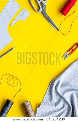 Sewing Wokrshop. Textile, Pattern, Scissors, Thread On Yellow Background Top-down Copy Space
