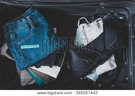 Luggage With Pile Of Clothes And Packing Everything Label On Them