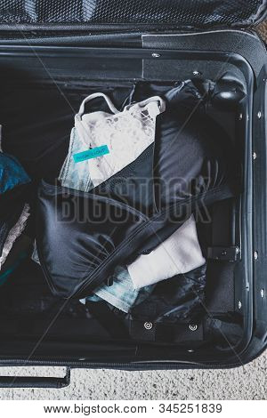 Luggage With Few Clothes Inside And Packing Light Label On Them