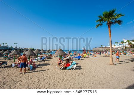 Canary Island Tenerife, Spain - 26 Dec, 2019: Tourists Are Relaxing On Playa La Pinta Puerto Colon. 