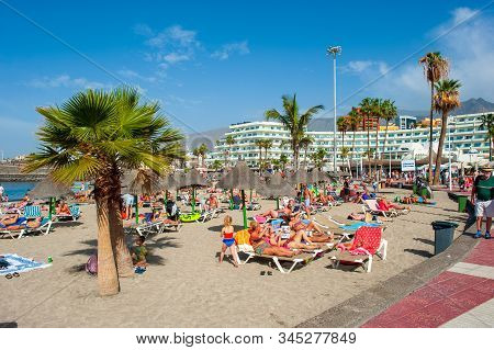 Canary Island Tenerife, Spain - 26 Dec, 2019: Tourists Are Relaxing On Playa La Pinta Puerto Colon. 