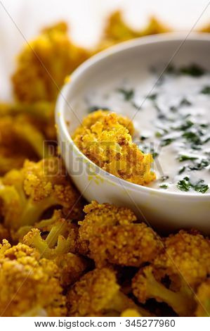 Close Up Crispy Cauliflower With Sauce And Greens With Selective Focus