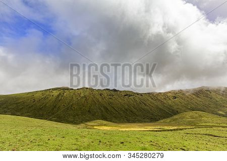 White Clouds And Blue Sky Above The Rim Of The Corvo Caldera On The Island Of Corvo In The Azores, P