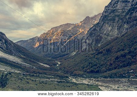 Morning Sun Illuminating A Lush Mountain Valley.