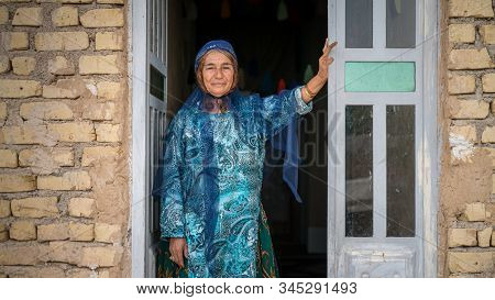 Shiraz, Iran - May 2019: Qashqai Turkish Woman Wearing A Traditional Dress Standing At The Entrance 