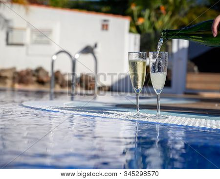 Pool Party With Two Glasses Of Bubbles White Champagne Or Cava Wine, Romantic Event On All Inclusive