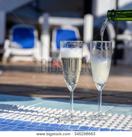 Pool Party With Two Glasses Of Bubbles White Champagne Or Cava Wine, Romantic Event On All Inclusive