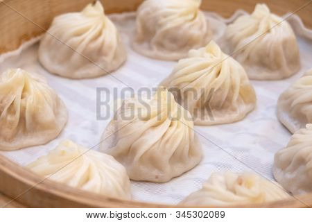 Xiao Long Bao Soup Dumpling Buns With Chopsticks In Restaurant (traditional Chinese Food) In Taipei