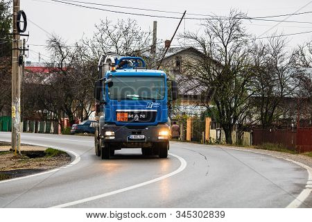 Cars On The Asphalt Road. Utility Car (from Rohrer Group Company) In Traffic.  Targoviste, Romania,