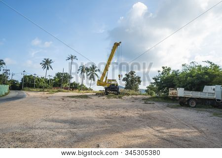 Yellow Automobile Crane With Risen Telescopic Boom Outdoors. Mobile Construction Crane On A Construc