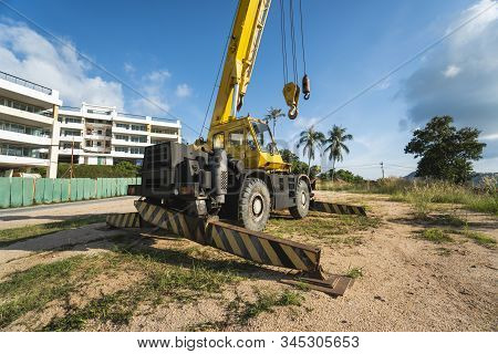 Yellow Automobile Crane With Risen Telescopic Boom Outdoors. Mobile Construction Crane On A Construc