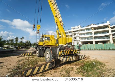 Yellow Automobile Crane With Risen Telescopic Boom Outdoors. Mobile Construction Crane On A Construc