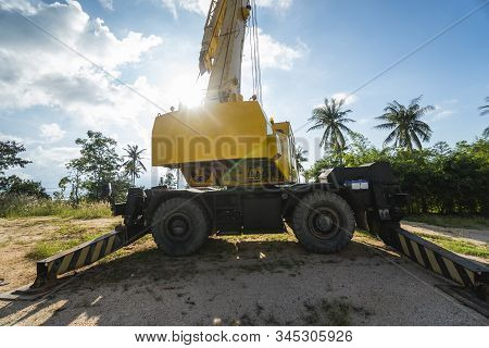 Yellow Automobile Crane With Risen Telescopic Boom Outdoors. Mobile Construction Crane On A Construc