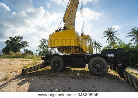 Yellow Automobile Crane With Risen Telescopic Boom Outdoors. Mobile Construction Crane On A Construc