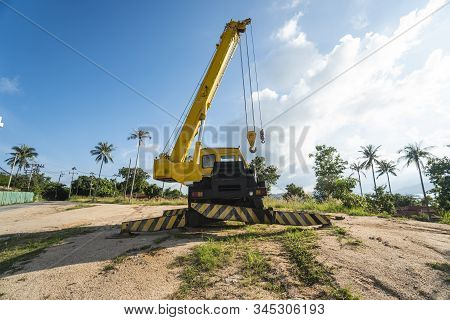 Yellow Automobile Crane With Risen Telescopic Boom Outdoors. Mobile Construction Crane On A Construc