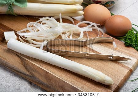 Bunch Of Fresh Uncooked White Asparagus And Peeler Knife, How To Peel Asparagus Vegetables, Close Up